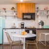 kitchen with ample counter-space, connected dining area and and modern appliances