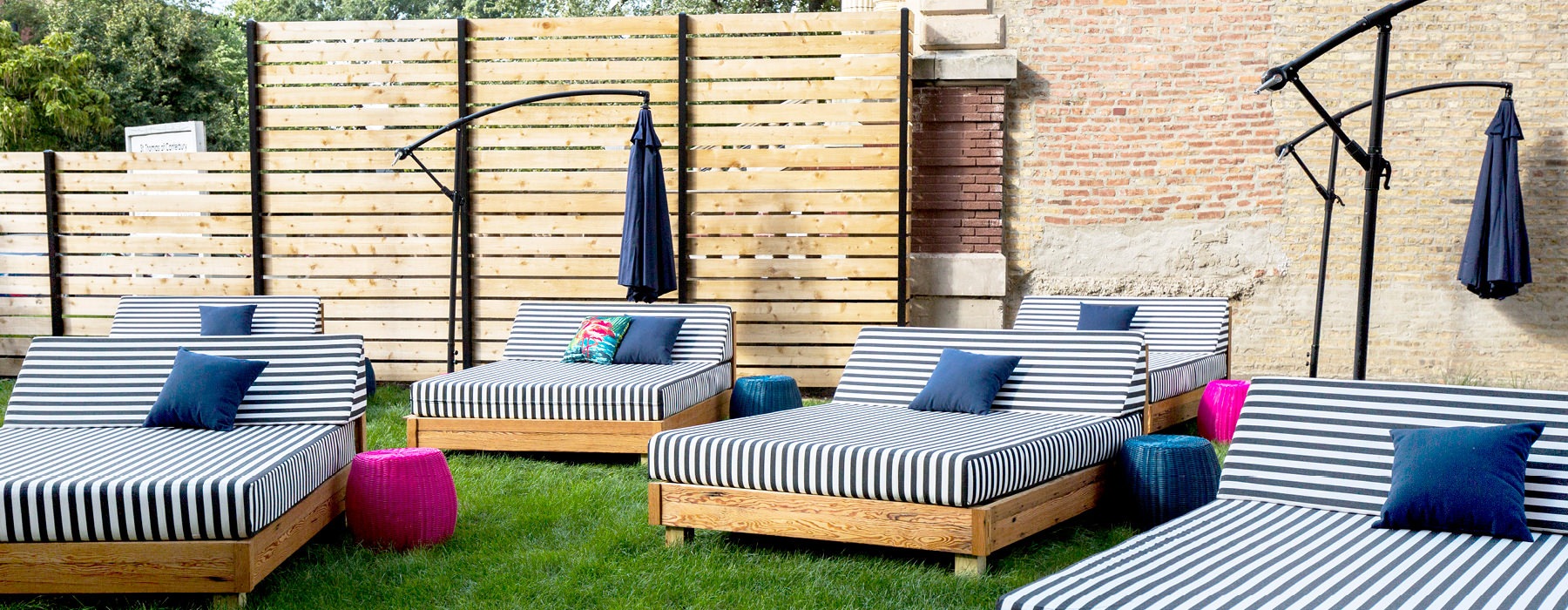 plush reclining loungers with umbrella shading in Backyard